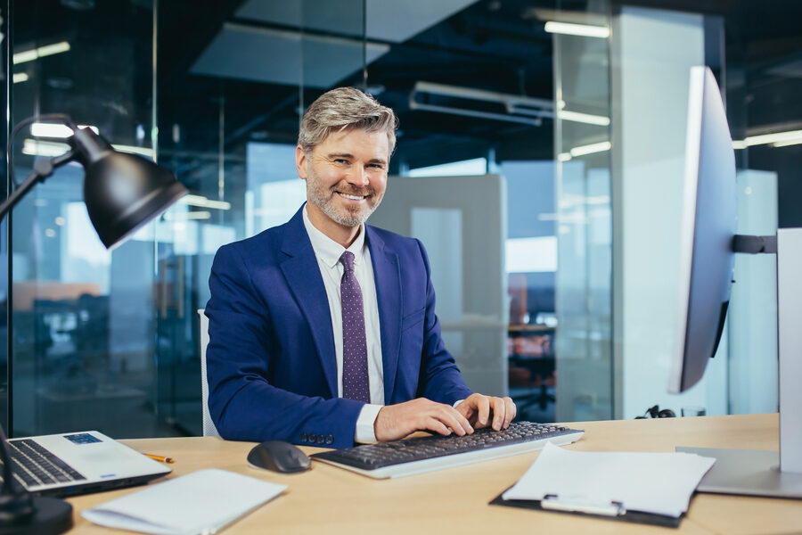 Portrait of a successful experienced gray-haired broker man, business man working